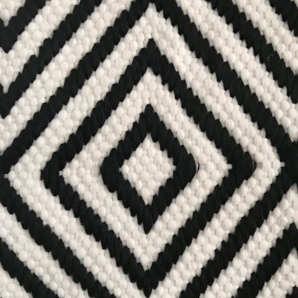 Black and white diamond patterned handwovern polypropylene outdoor rug